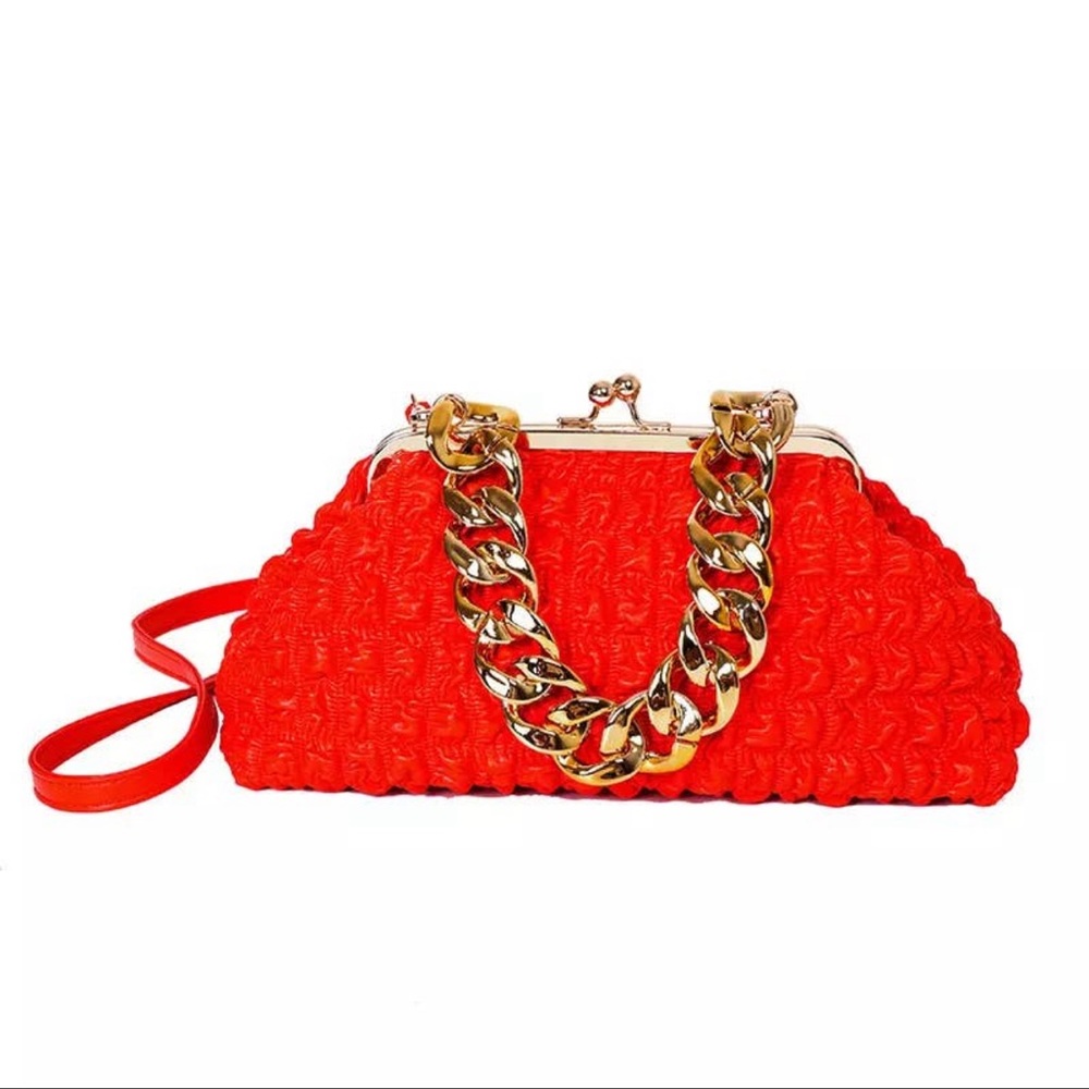 Large size women's handbag with gold chunky chain handle.